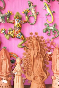 Photo of Our Lady of Guadalupe statues and talavera frogs & iguanas.