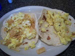 Photo of a Migas with Cheese Taco and a Potato and Egg Taco.
