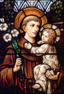 Photo of a stained glass image of St. Anthony of Padua and the Christ child.